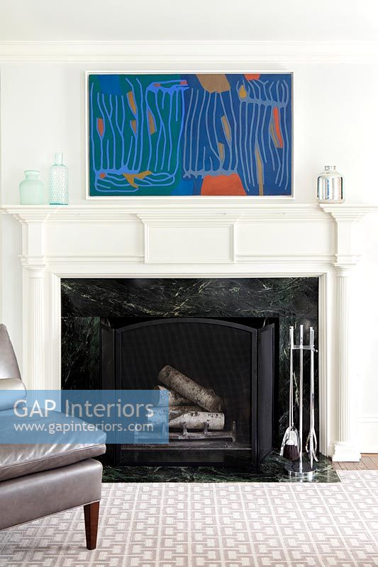 Modern painting and classic fireplace
