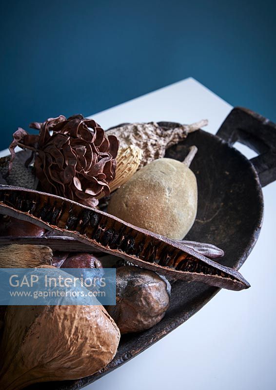 Dried fruits and seed pods in rustic platter