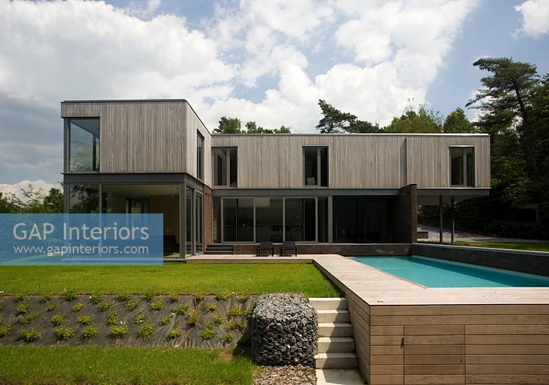 Modernist house and lawned garden with pool