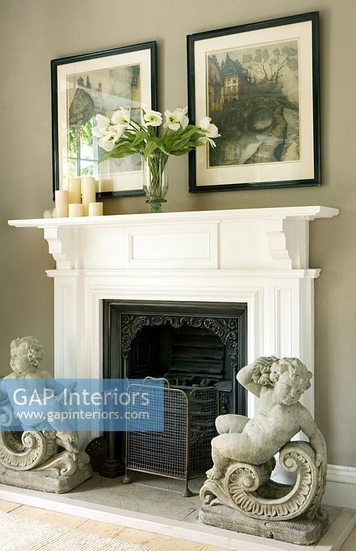 Classic sculptures by fireplace