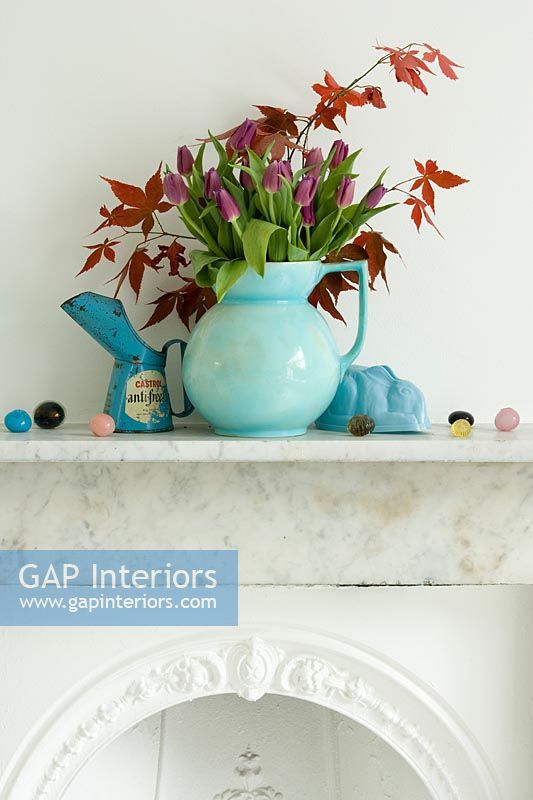 Jug of Tulip flowers and Maple foliage on mantlepiece