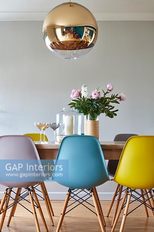 Colourful Eames chairs at dining table