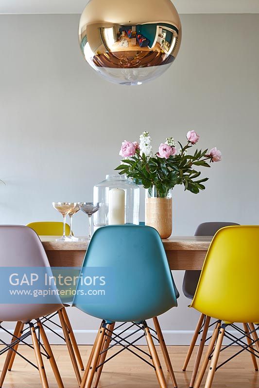 Colourful Eames chairs at dining table
