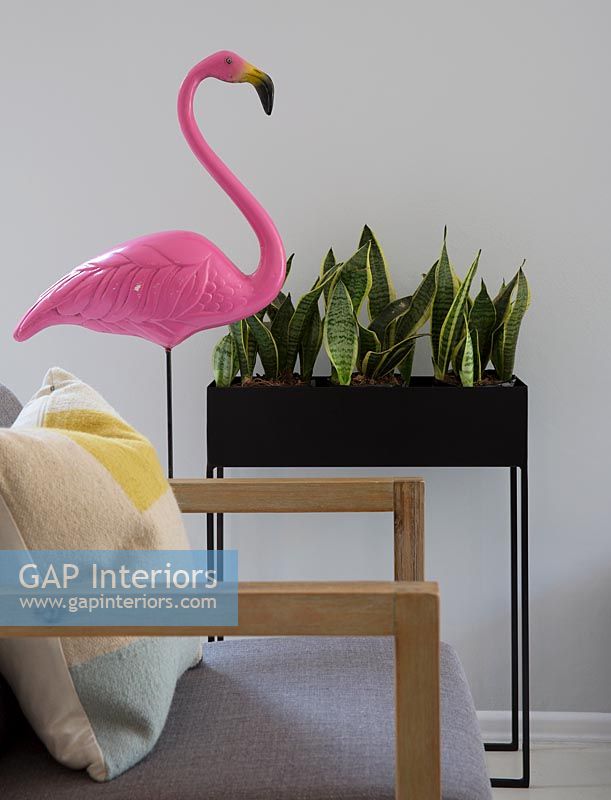 Flamingo ornament and metal plant stand