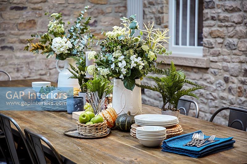 Flowers and crockery on dining table
