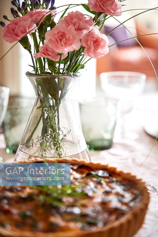 Vase of Carnation flowers on dining table