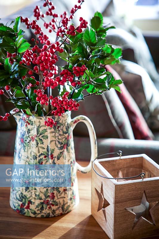 Vase of berries and Holly foliage