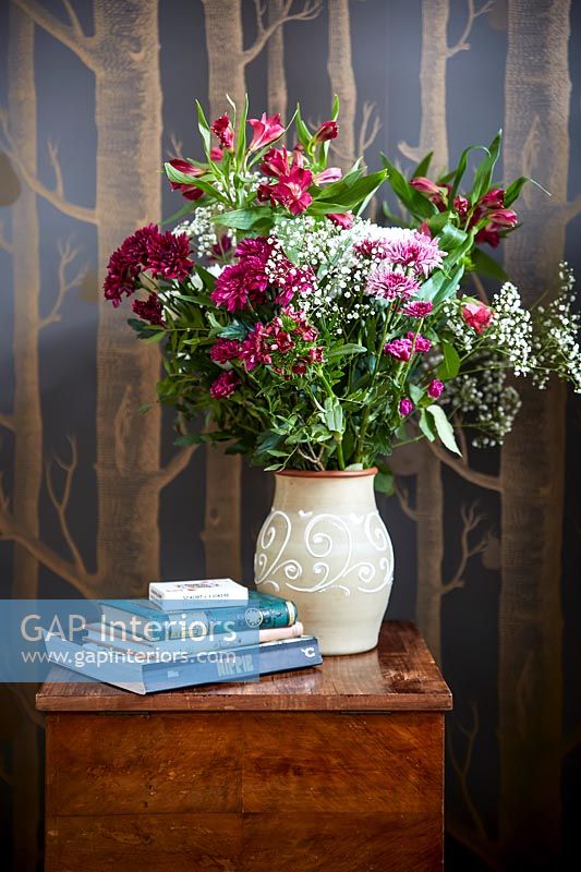 Flower arrangement in a vase on a bedside table