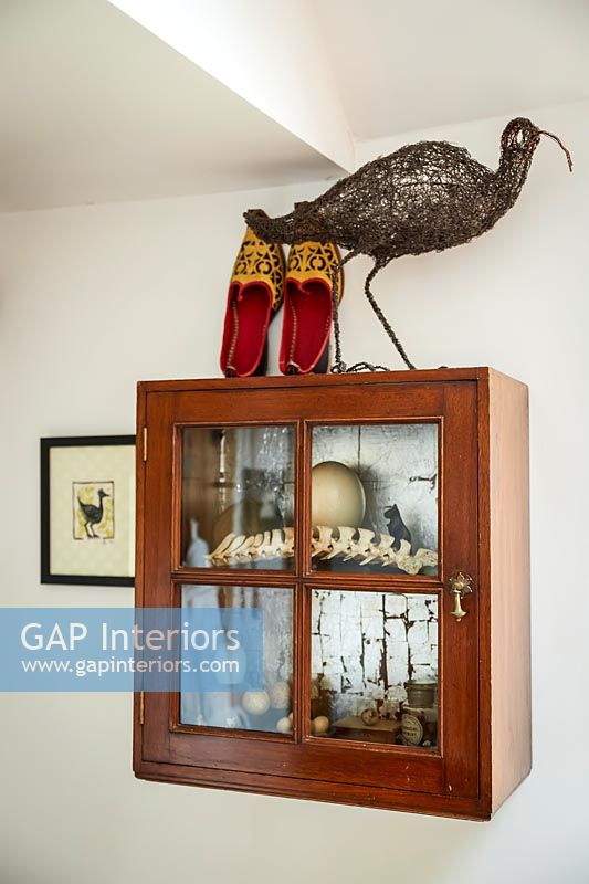 Wooden display cabinet of objects