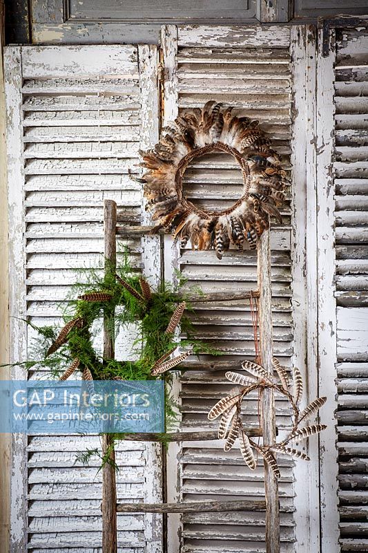 Decorative wreaths on wooden shutters