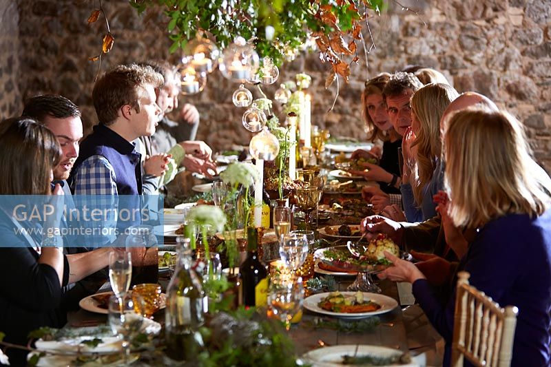 People eating at the decorated dining table 