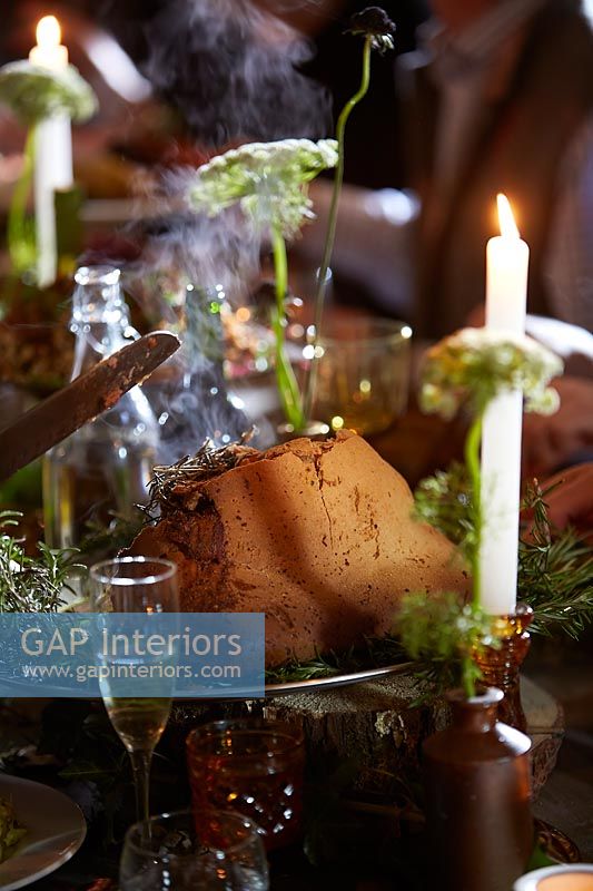 Detail of salt dough wrapped lamb at the decorated dining table 