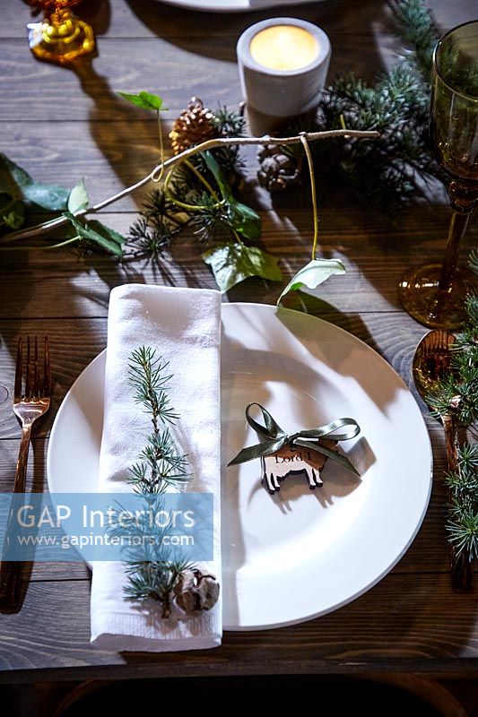 Place settings on a decorated wooden table