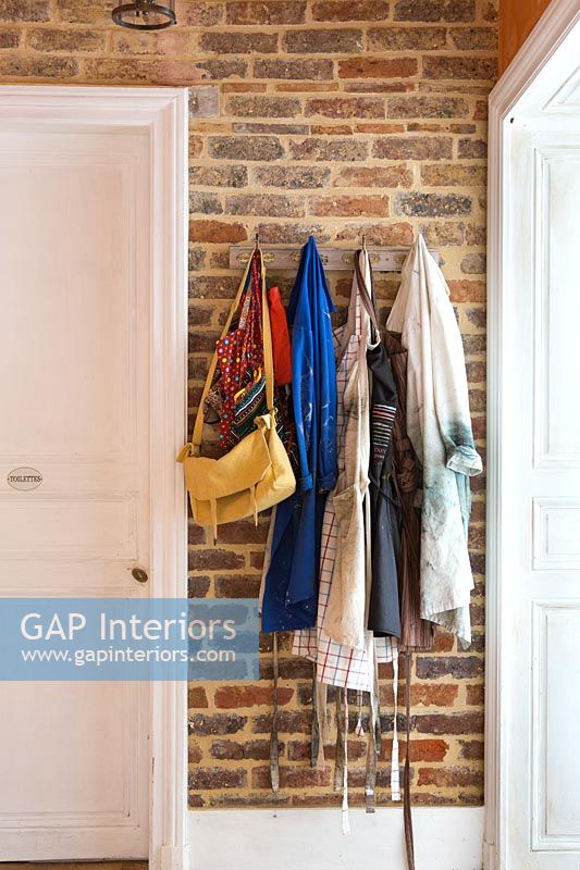 Clothes and bags hanging on wall hooks
