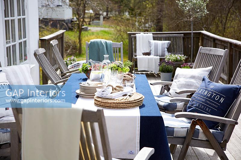 Outside dining table and chairs ready for entertaining 