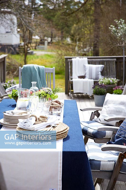 Outside dining table and chairs ready for entertaining
