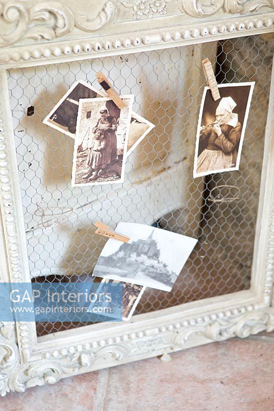Painted wooden picture frame with postcard display