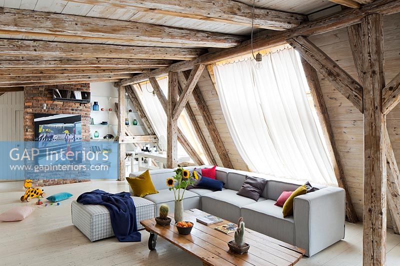 Open plan living space with exposed beams