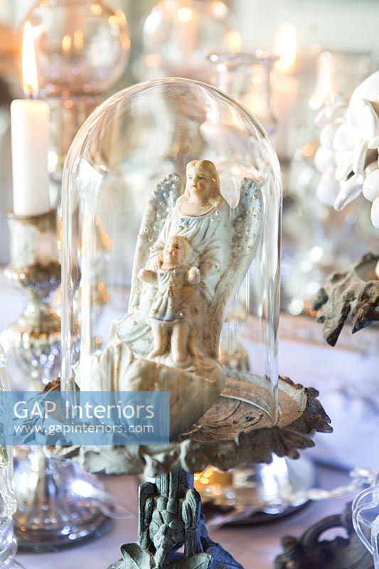 Detail of vintage religious figures in glass dome