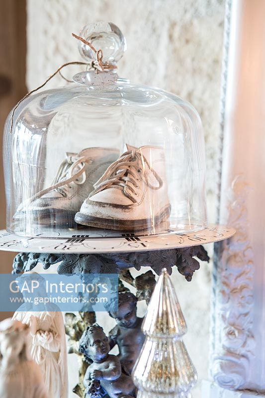 Detail of vintage shoes in glass dome