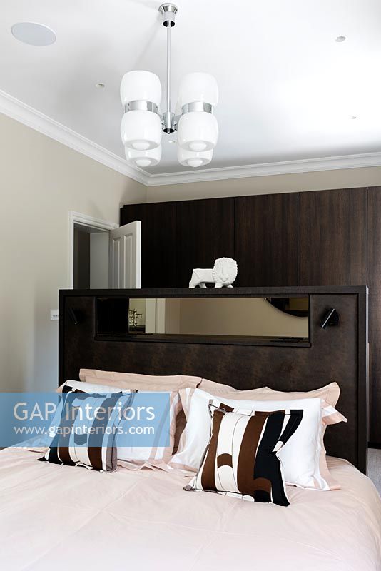 Contemporary bedroom with Italian 1960's ceiling light and porcelain lion ornament