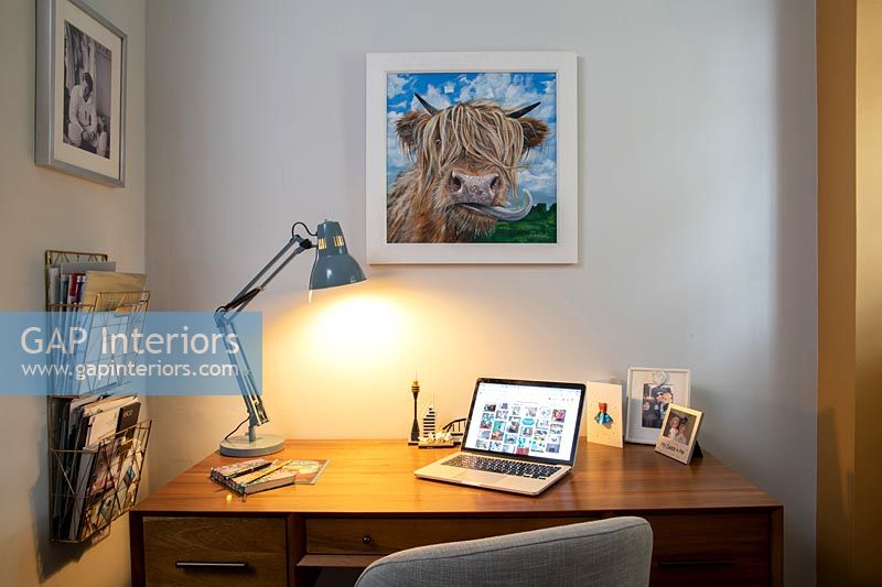 Home office with cow picture