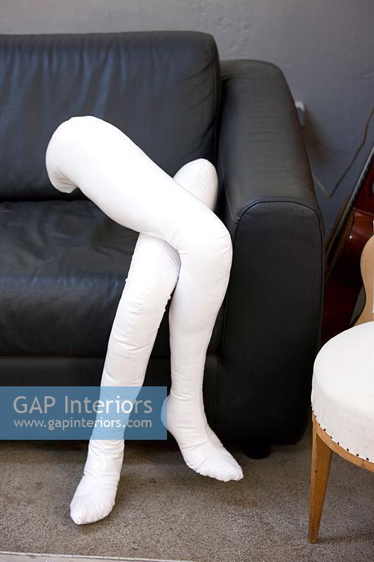 Detail of mannequins legs on sofa