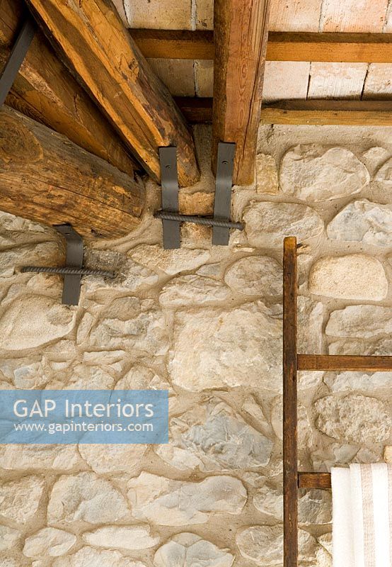 Detail of rustic stone wall and wooden beams