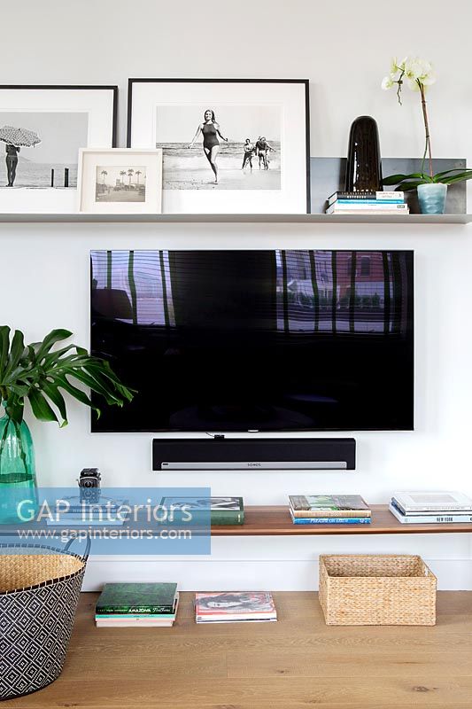 Wall mounted flat screen television in contemporary living room