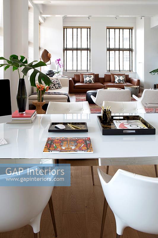 Modern white dining table in open plan apartment