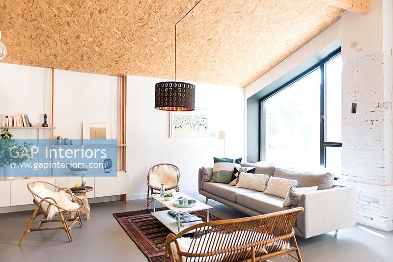 Modern living room with sloped cork covered ceiling