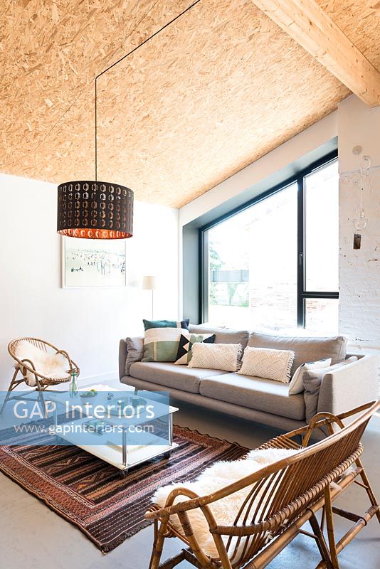 Modern living room with sloping cork covered ceiling