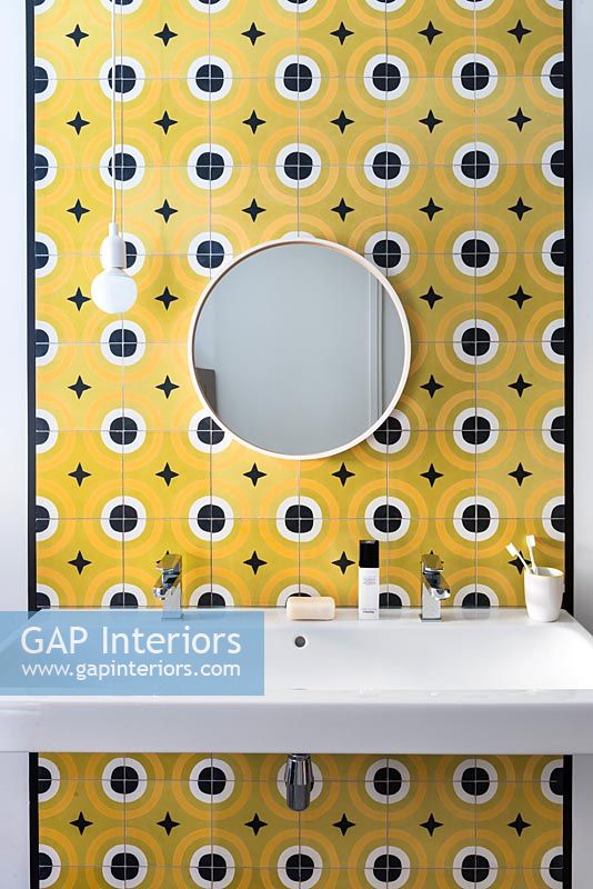 Bathroom sink with yellow and black tiled feature wall 