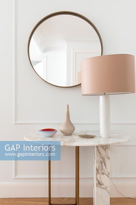 Marble console table with lamp and mirror in hallway