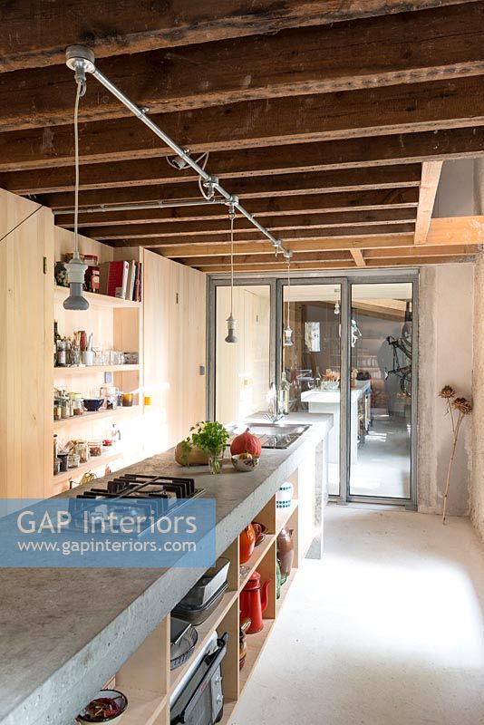 Galley kitchen with exposed beams and concrete worktop