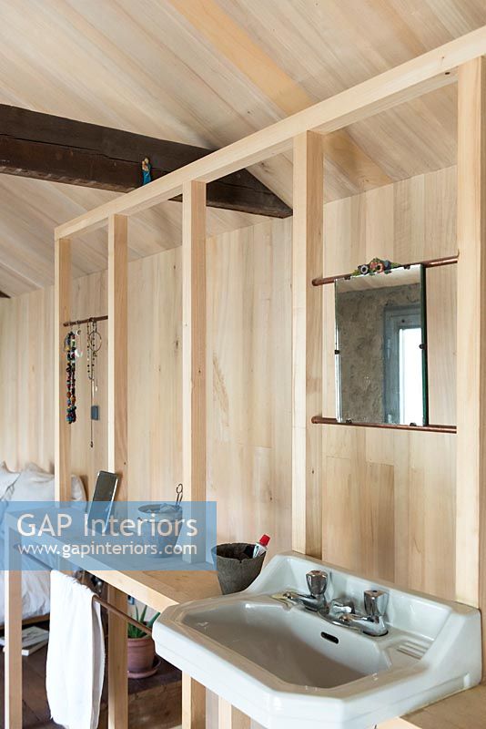 Timber frame bathroom in wooden bedroom 