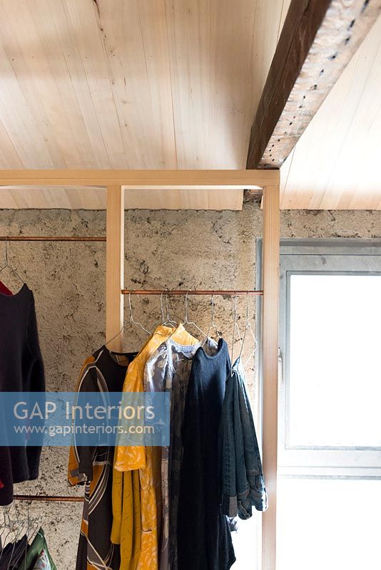 Open timber frame wardrobe and exposed wooden beams 