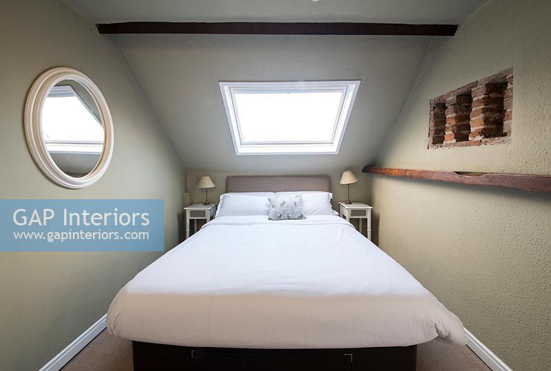 Double attic bedroom with open brick alcoves 