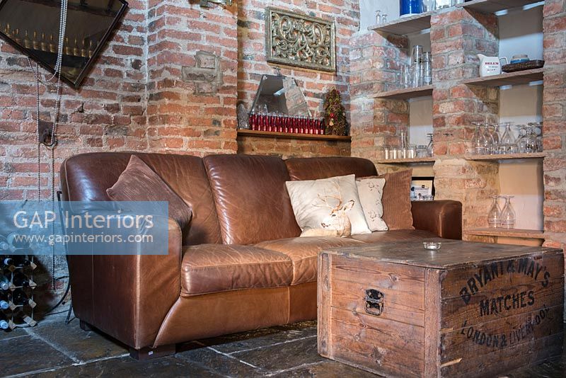 Classic leather sofa with brick wall and storage