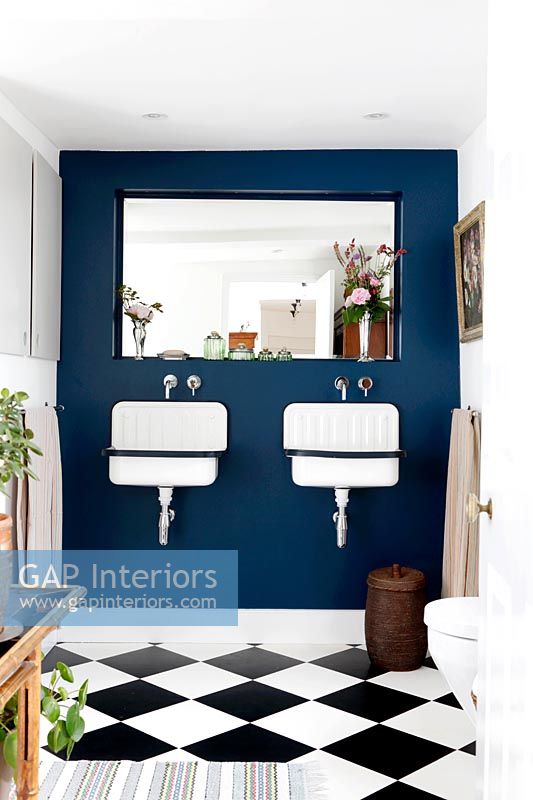 Painted feature wall with twin sinks in classic bathroom 
