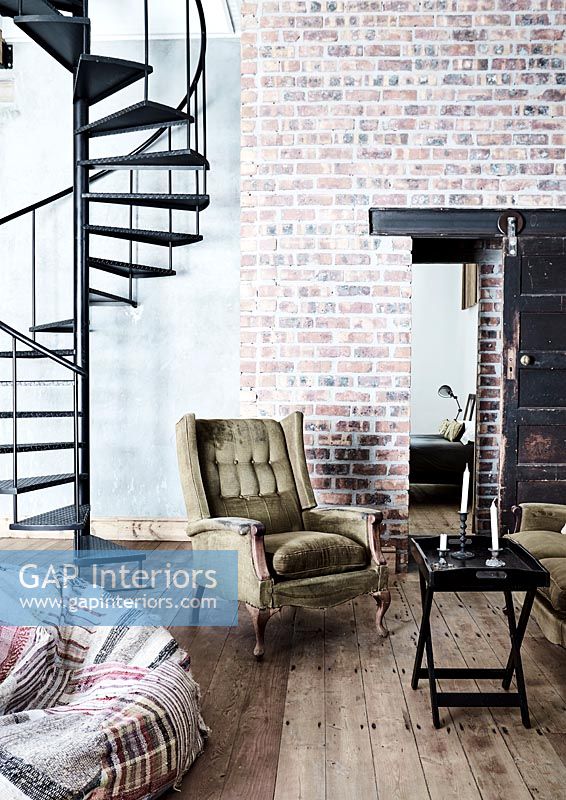 Modern industrial living room with spiral staircase  