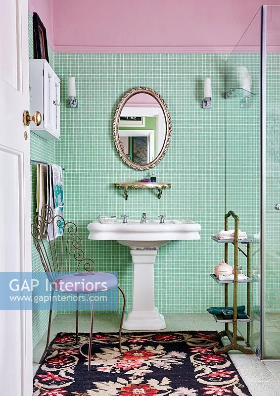 Classic bathroom with green tiled wall and period details 