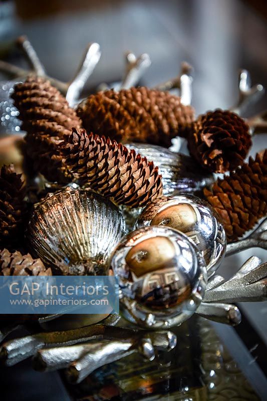 Decorative pine cones and silver baubles