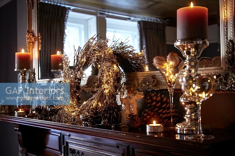 Candles and wreath on fireplace at Christmas 