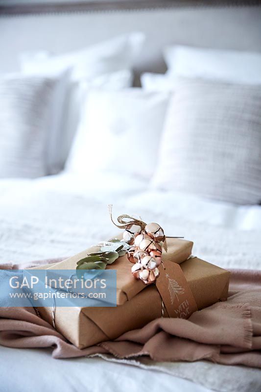 Gifts wrapped in brown paper with decorative jingle bells 