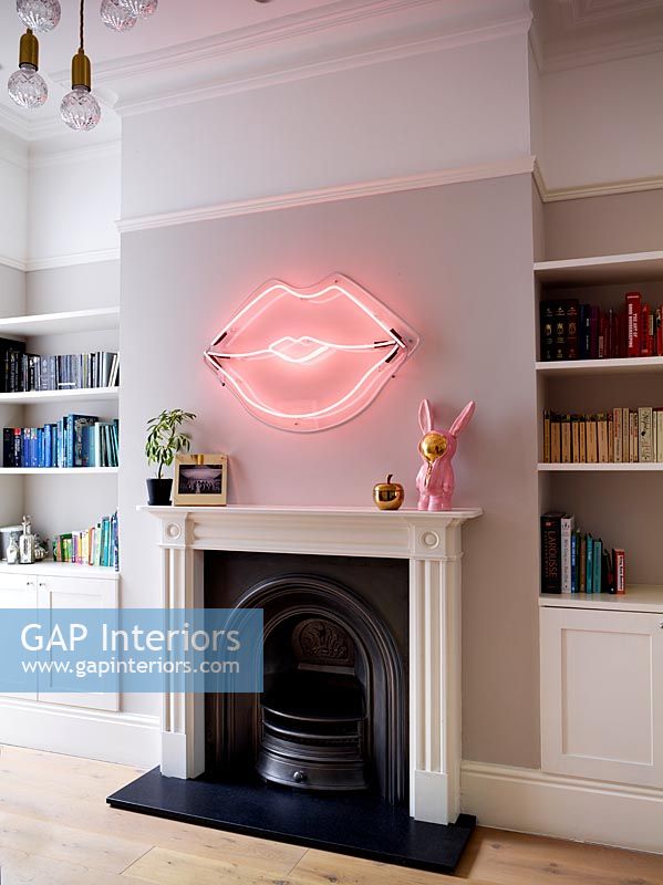Pink neon lips - artwork above fireplace 