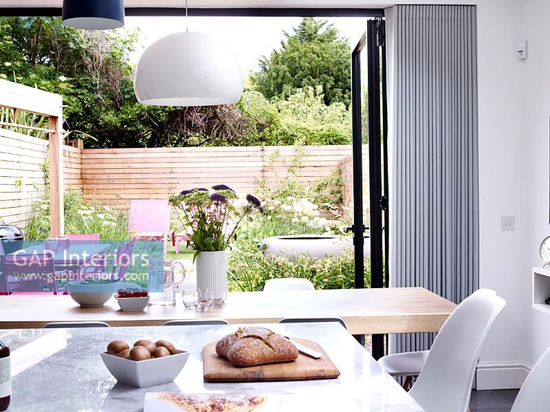 Patio doors in modern kitchen open to garden 