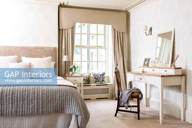 Classic bedroom with dressing table and window seat