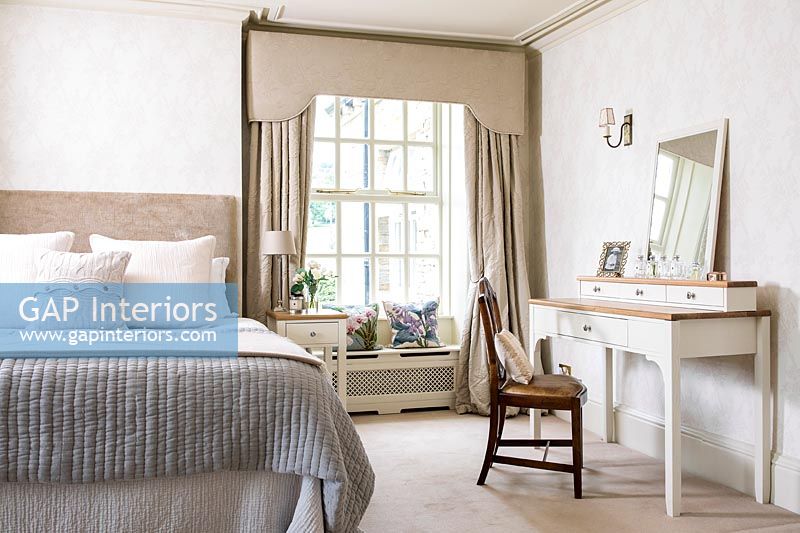 Classic bedroom with dressing table and window seat