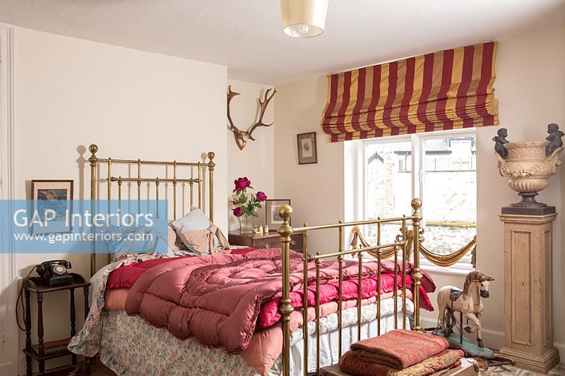 Iron bed in country bedroom 